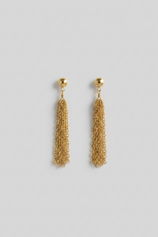 Gold chain tassel earrings on a black background